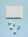 Yahtzee game in progress. Rolling dice, pencil and score sheet on a blue background.