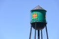 Traditional green water tower with sign for Del Monte Food Products