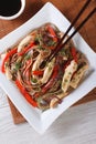 Yakisoba with chicken and vegetables close-up top view vertical