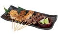 Yakitori Japanese-Style Grilled Chicken Skewers with chicken and internal organ served with sliced lime. Royalty Free Stock Photo