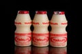 Yakult fermented milk drink on black isolated background Royalty Free Stock Photo