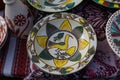 Yakushyntsi, Ukraine, handmade ceramic clay plate on sale, Podillia style bird and flower ornament painting, ethno festival