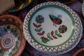 Yakushyntsi, Ukraine, traditional Ukrainian clay plate on sale, Podillia style flower, bird and ornament painting