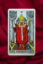 THE FOOL major tarot card of Rider Waite deck on red fabric background