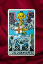 THE FOOL major tarot card of Rider Waite deck on red fabric background