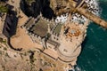 Yalta, Crimea - April 21, 2019: Tourists examine and take pictures on the background of the famous Gothic Castle Swallow`s Nest