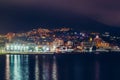 Yalta embankment at night, city buildings lights reflected in black water, beautiful resort in Crimea with mountains and sea Royalty Free Stock Photo