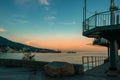 Yalta embankment with a view of the old lighthouse at sunset. Port of Yalta on the Black sea Royalty Free Stock Photo