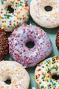 Yam yam. Close up shot of various delicious colourful round glazed donuts with sprinkles Royalty Free Stock Photo