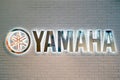 Yamaha music brand lettering and logo on white brick wall, illustrative editorial - Moscow, Russia, January 27, 2021