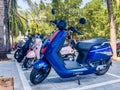YAMAHA NIU blue scooter motoroler with electrical engine stands on a parking