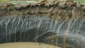 YAMAL PENINSULA, RUSSIA - JUNE 18, 2015: Expedition to the giant funnel of unknown origin. The crater wall from the Royalty Free Stock Photo