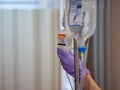 Yamanashi, Japan - 21.3.20: A nurse checking a patient`s iv drip in a hospital or clinic