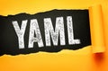YAML text revealed in bold typography on torn paper background, stands for Aint Markup Language, it is a human-readable data Royalty Free Stock Photo