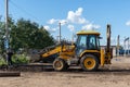 Yanaul, Russia August 26, 2020: a worker and a tractor perform road repairs Royalty Free Stock Photo