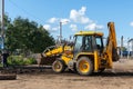 Yanaul, Russia August 26, 2020: a worker and a tractor perform road repairs Royalty Free Stock Photo