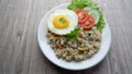 Yang Chow fried rice with slice tomato and cucumber on a white plate