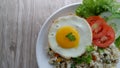 Yang Chow fried rice with slice tomato and cucumber on a white plate Royalty Free Stock Photo