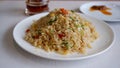 Yang Chow fried rice on a white plate with chilli oil.