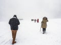People hike on Yangcao Mountain in winter season