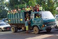 Yangon, Burma Myanmar - November 29, 2012. Old green truck with many Burmese workers in truck body. Burmese street life Royalty Free Stock Photo