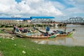 A boat arriving at Botahtaung jetty, carrying Burmese passengers on the Yangon River. Myanmar, Asia