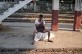 A local man sits on a couple of rice bags at the platform of the circle train