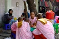 Buddhist nuns eating snacks on street