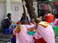 Buddhist nuns eating snacks on street