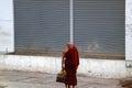 Myanmarese Buddhist monk standing beside the road in Yangon