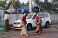 Myanmese woman with thanakha Myanmar powder on their face put the plastic basket on her head, from going to market