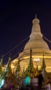 Shwedagon pagoda at night with people praying, meditating and visiting. Yangon. Myanmar