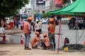 The man are working construction with orange color of safety helmet and safety vest on city background.