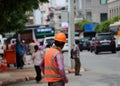 The man are working construction with orange color of safety helmet and safety vest on city background. Royalty Free Stock Photo