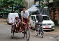 Myanmarese passenger sitting on the bicycle tricycle taxi in the street of Yangon.