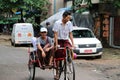 Myanmarese passenger sitting on the bicycle tricycle taxi in the street of Yangon.