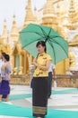 Yangon, Myanmar - June 22, 2015: An unidentified young woman sta