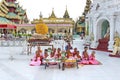 Group of burmese nuns sitting and praying in front of Shwedagon pagoda 1 of 5 sacred places