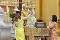 People buddhist devotees bathing for blessings wash the buddha statue at Shwedagon pagoda 1 of 5 sacred places
