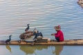 YANGSHUO, CHINA, 6 DECEMBER 2019: Cormorant fisherman on the Li River in Yangshuo