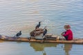 YANGSHUO, CHINA, 6 DECEMBER 2019: Cormorant fisherman on the Li River in Yangshuo