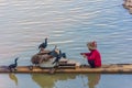 YANGSHUO, CHINA, 6 DECEMBER 2019: Cormorant fisherman on the Li River in Yangshuo