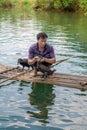 Chinese man fishing with cormorants birds in Yangshuo, Guangxi region. China.