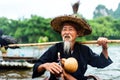 Yangshuo, China - July 27, 2018: Cormorant fisherman on a bamboo rafts on Li river in Yangshuo near Guilin in China
