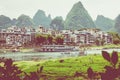 YANGSHUO, CHINA - MAY 26, 2018: Scenic landscape at Yangshuo County of Guilin. Li River (Lijiang River). Pleasure boats at the pi