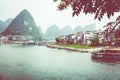 YANGSHUO, CHINA - MAY 26, 2018: Scenic landscape at Yangshuo County of Guilin. Li River (Lijiang River). Pleasure boats at the pi