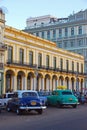 Classic vintage old Cuban yank tank tanks car in Havana Cuba with Yellow Building background