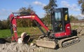 Yanmar compact excavator working on a construction site Royalty Free Stock Photo