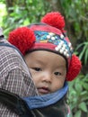 Yao hilltribe baby in traditional headdress, Northern Laos Royalty Free Stock Photo