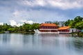 Yao-Yueh Fang Stone boat structure in a pound in Chinese Singapore garden with blue cloudish and reflection Royalty Free Stock Photo